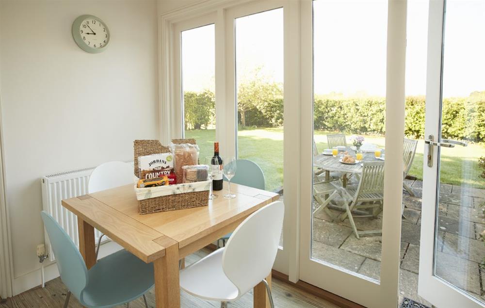 Breakfast room with seating fro four guests and views of the garden at Tufton Croft, Wittersham