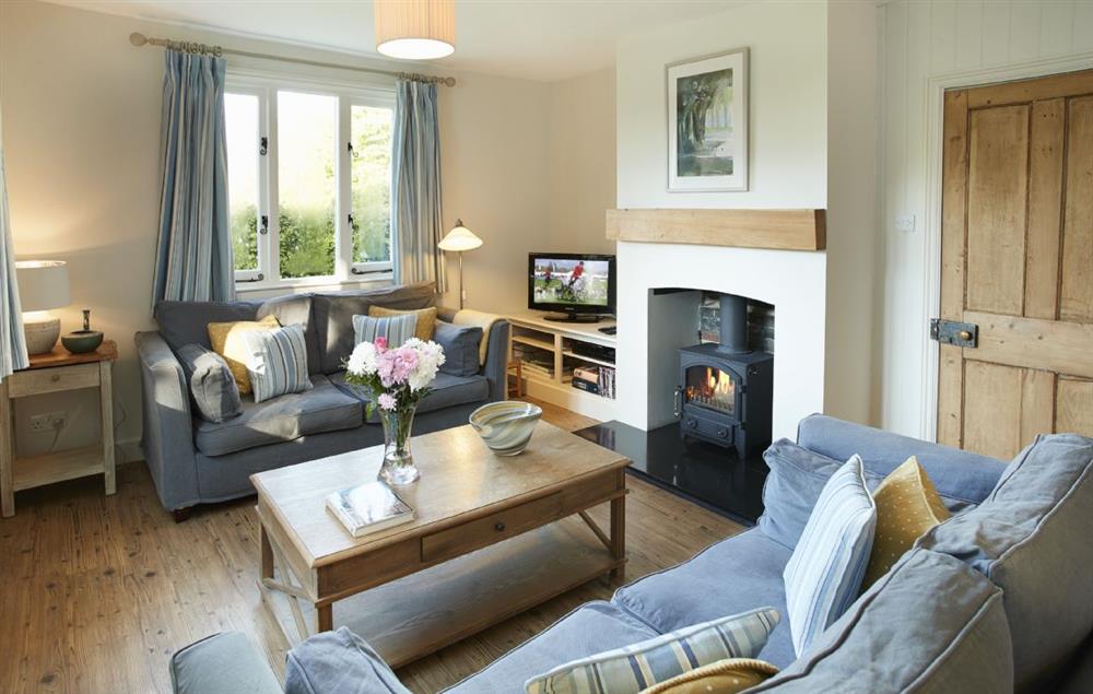 Open plan sitting room with wood burning stove and dining area at Tufton Croft, Wittersham