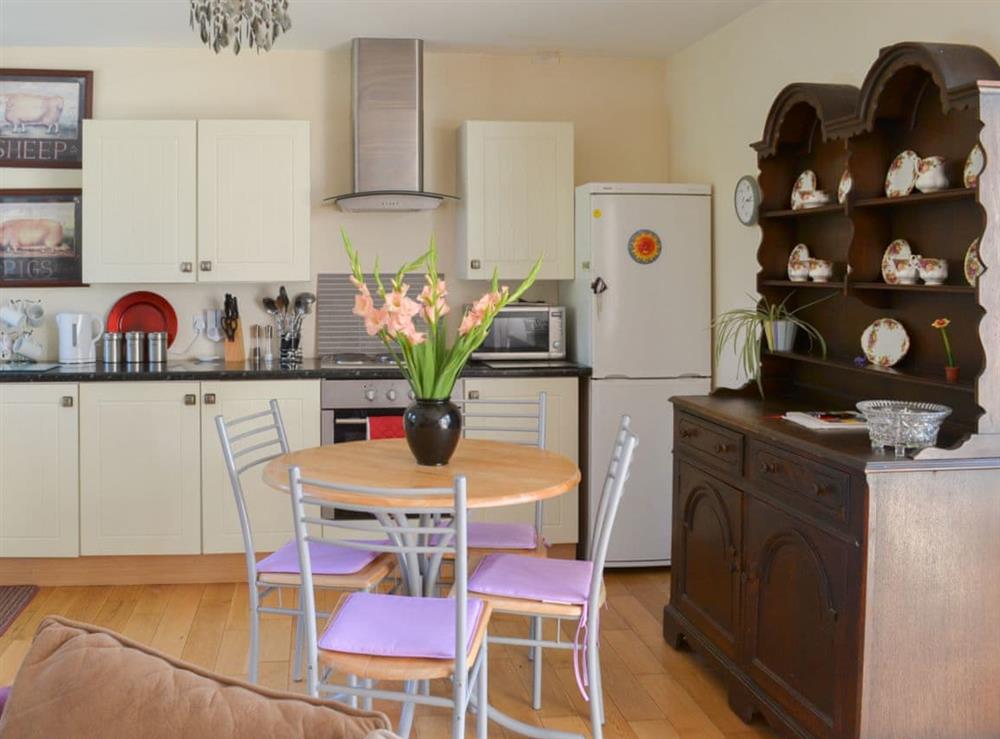Kitchen/dining area with traditional farmhouse furniture at Tulip Lodge in Tideford Cross, near Saltash, Cornwall