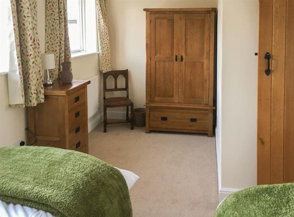 Twin bedroom with lovely dressing area at Tuppence Cottage in Dulverton, Somerset