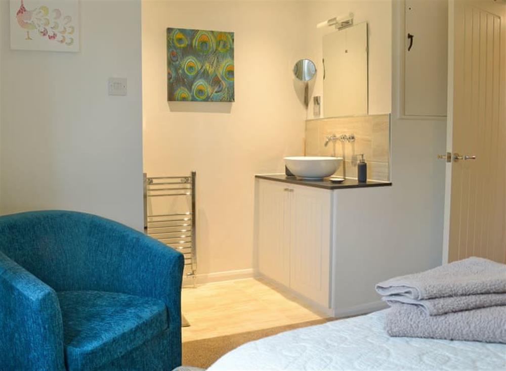 Spacious double bedroom with en-suite shower cubicle (photo 3) at Turnpike Cottage in Biddestone, near Chippenham, Wiltshire