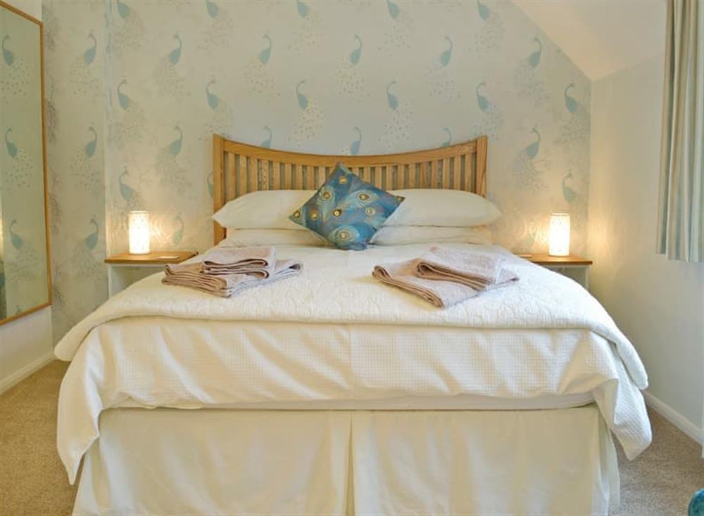 Spacious double bedroom with en-suite shower cubicle at Turnpike Cottage in Biddestone, near Chippenham, Wiltshire