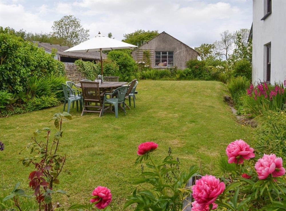 Lawned garden area with outdoor furniture at Tutchenor Farm in Patchacott, near Beaworthy, Devon