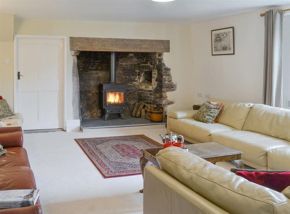 Welcoming living room with wood burner at Tutchenor Farm in Patchacott, near Beaworthy, Devon