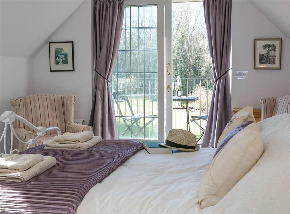 Double bedroom with balcony at Twisly North Lodge in Catsfield, near Battle, Sussex, East Sussex