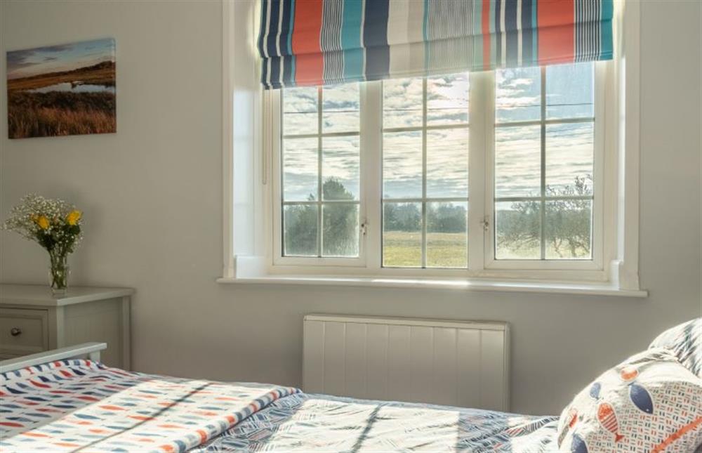 First floor: King-size bedroom with views at Twitchers Cottage, Titchwell near Kings Lynn