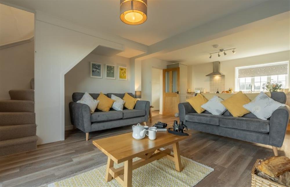 Ground floor: Sitting room with two comfortable sofas at Twitchers Cottage, Titchwell near Kings Lynn