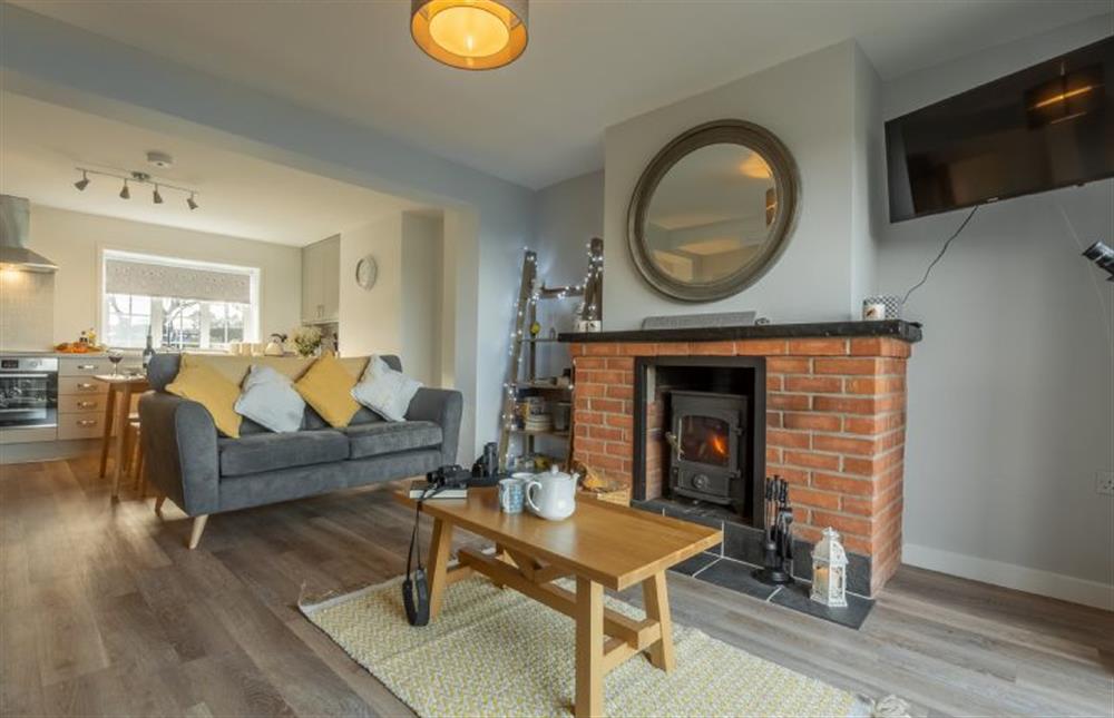 Ground floor: Sitting room with wood burning stove and views over the marshes towards the sea at Twitchers Cottage, Titchwell near Kings Lynn