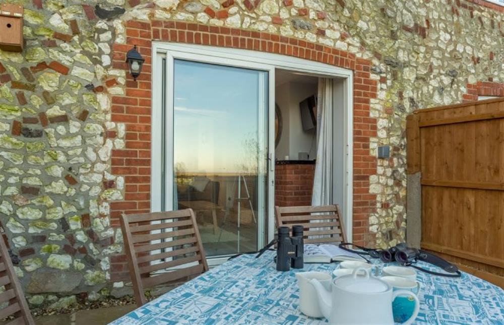 Outside:  French doors out onto the terrace/patio and rear garden at Twitchers Cottage, Titchwell near Kings Lynn