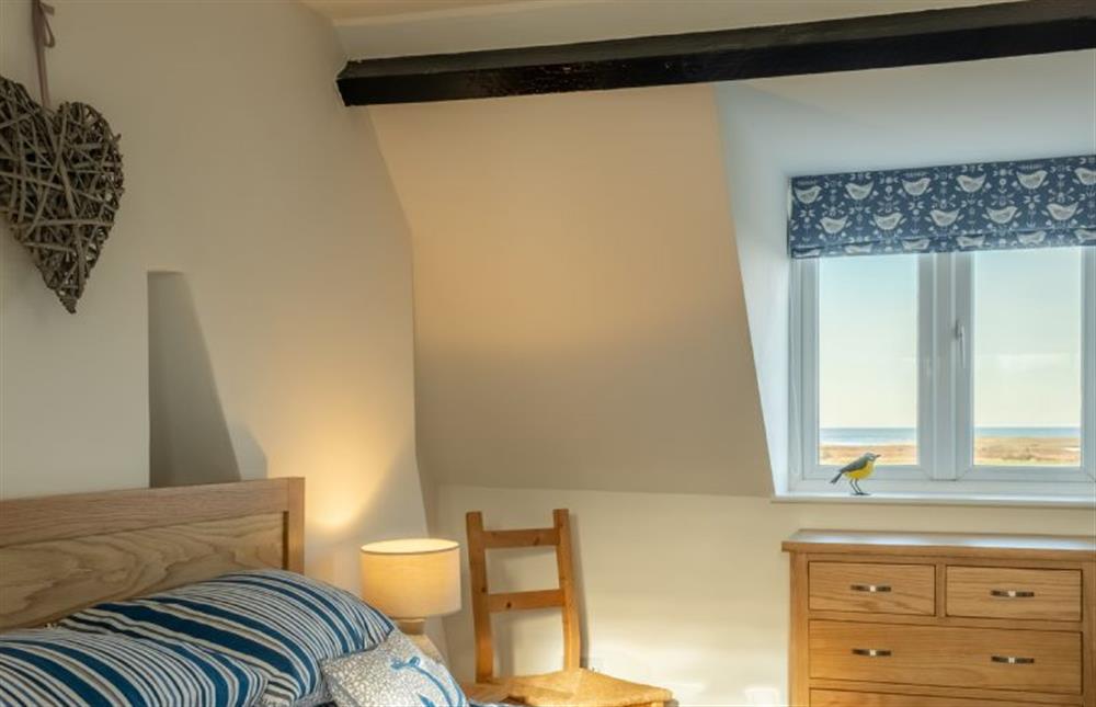 Second floor: King-size bedroom with dual aspect windows at Twitchers Cottage, Titchwell near Kings Lynn