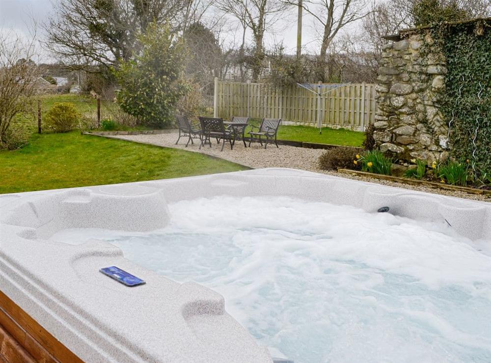 Luxurious hot tub within the shared garden at Ty Bach Twt in Dyffryn Ardudwy, near Barmouth, Gwynedd