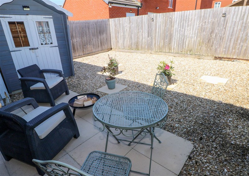 Enjoy a glass of wine on the patio at Ty Bach Twt, Llanelli