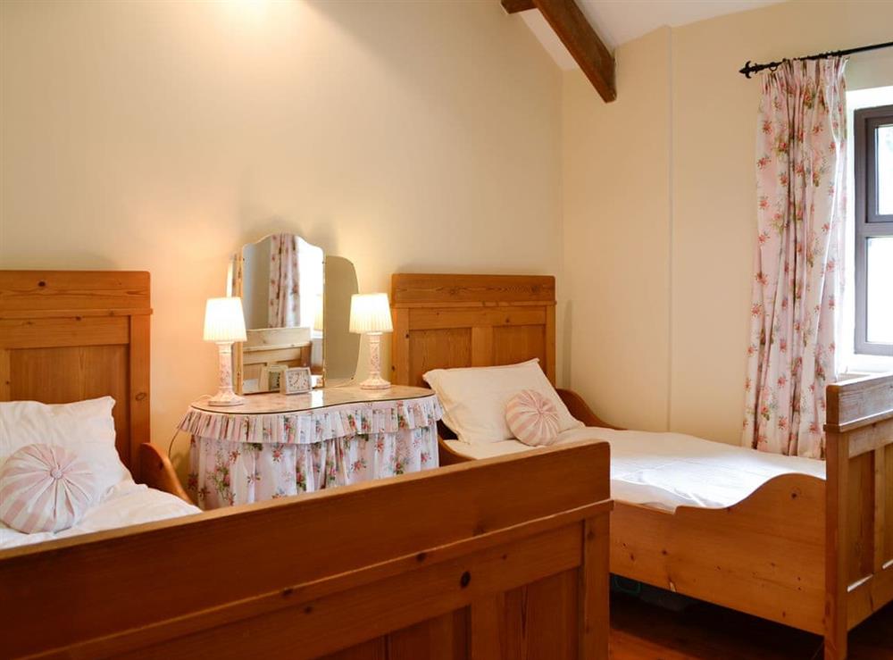 Charming bedroom with twin single beds at Ty Hir in Pontyates, near Kidwelly, Dyfed