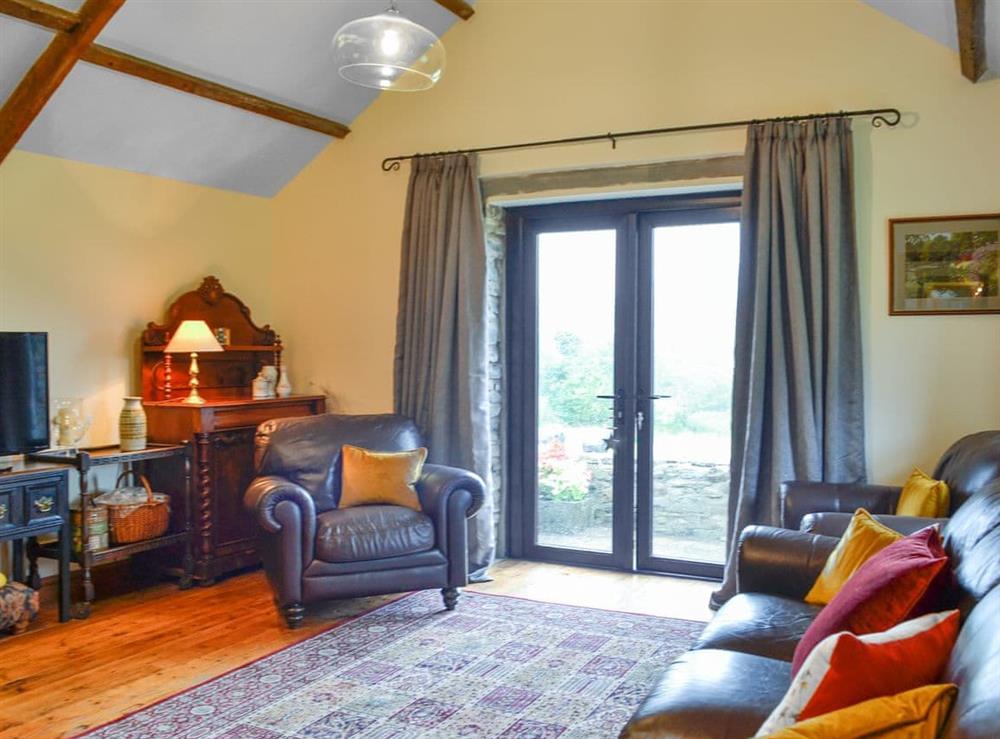 High-celinged living room with French doors to the garden at Ty Hir in Pontyates, near Kidwelly, Dyfed