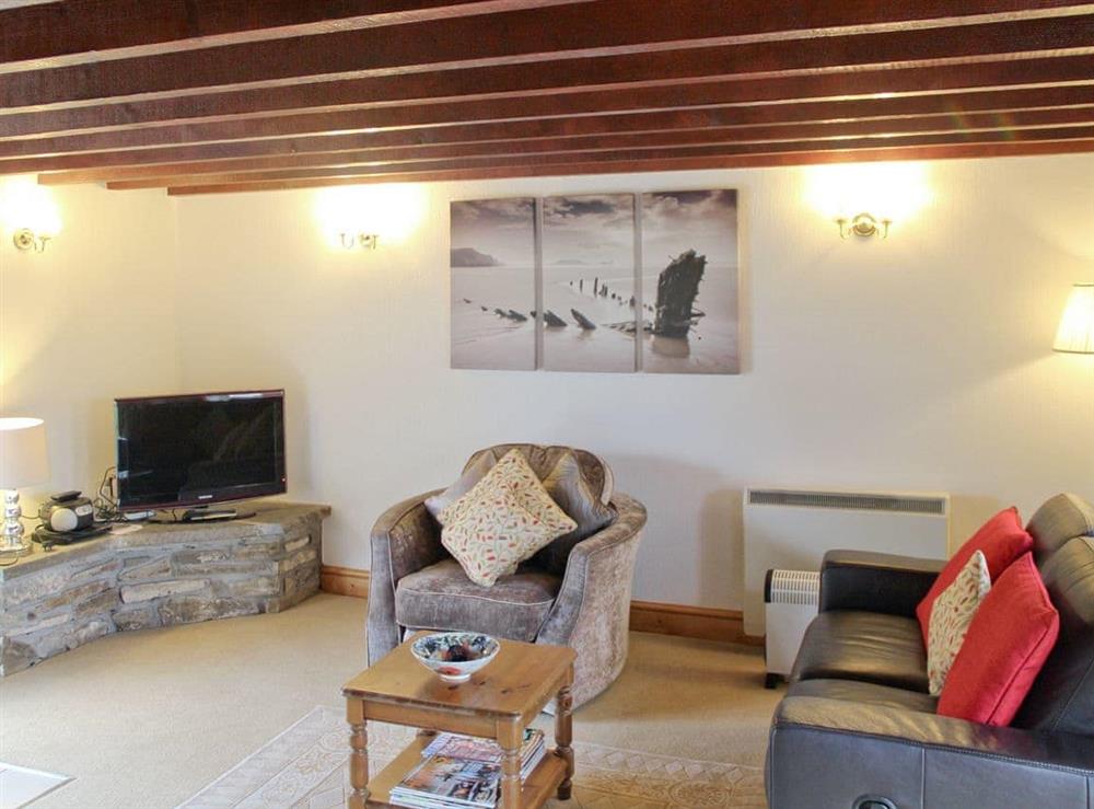 Living room with exposed wood beamed ceiling at Ty Llaethdy in Gowerton, Gower., West Glamorgan