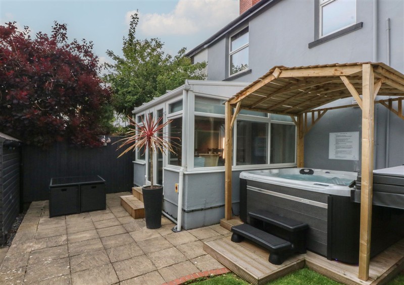 Enjoy a glass of wine on the patio at Ty Llwyd, Llandudno