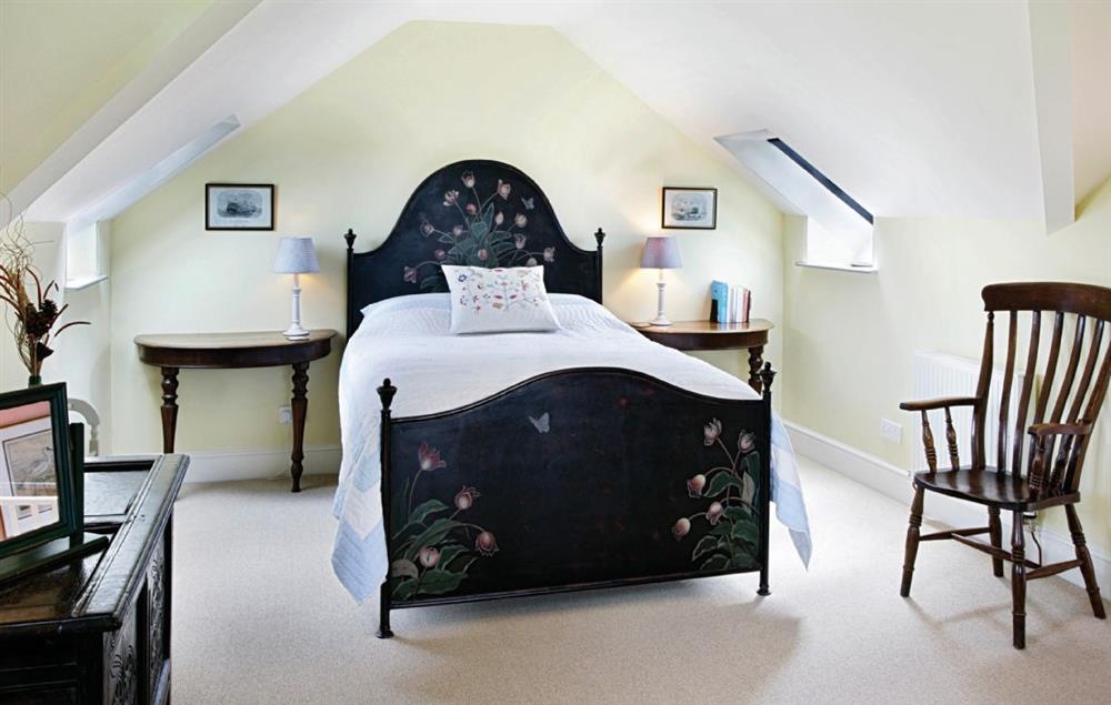 Master double bedroom with 5’ king-size bed and en suite bathroom with shower over bath at Ty Newydd, Bodnant Estate