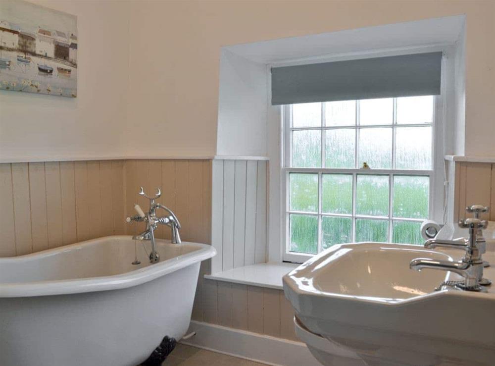Bathroom with roll-top bath at Ty Newydd in Llwyngwril, near Aberdovey, Gwynedd