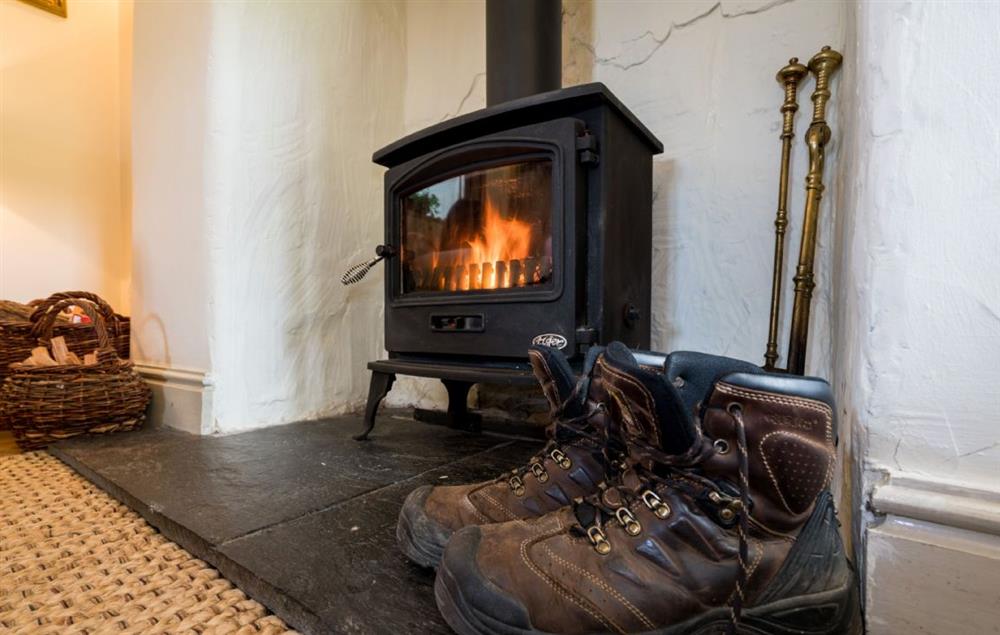 Enjoy the warmth of the woodburning stove after a day of exploring the area at Ty Uchar Ffordd, Bodnant Estate