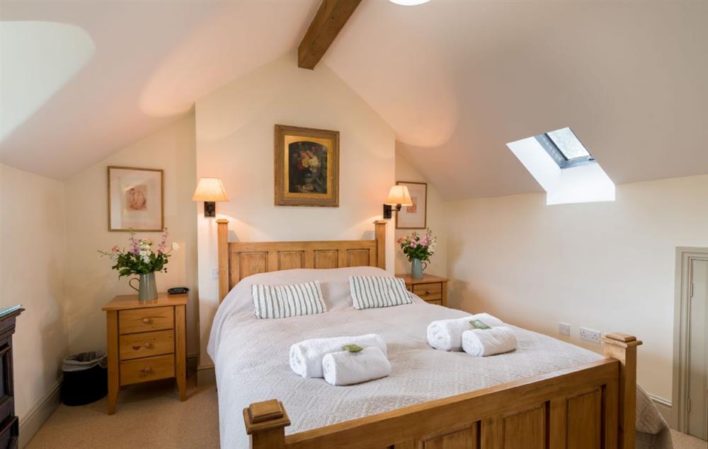 Master bedroom with 5’ king-size bed (photo 2) at Ty Uchar Ffordd, Bodnant Estate