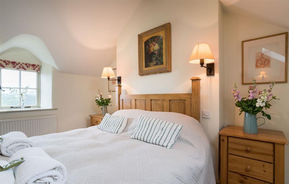 Master bedroom with 5’ king-size bed (photo 3) at Ty Uchar Ffordd, Bodnant Estate