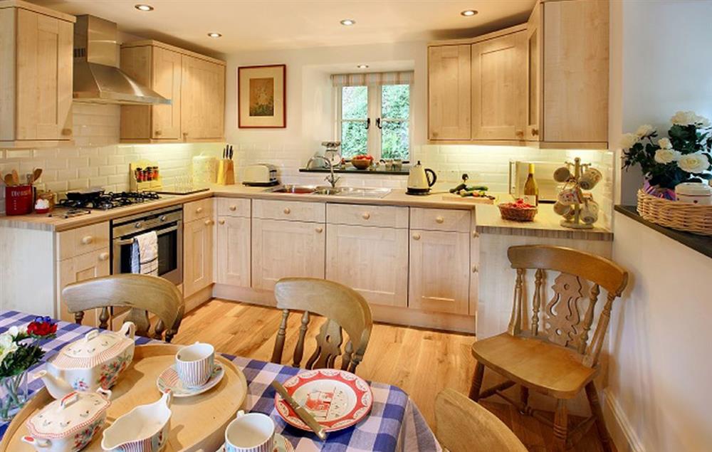 Kitchen/dining room with oak floor at Tyddyn Derwen, Bodnant Estate