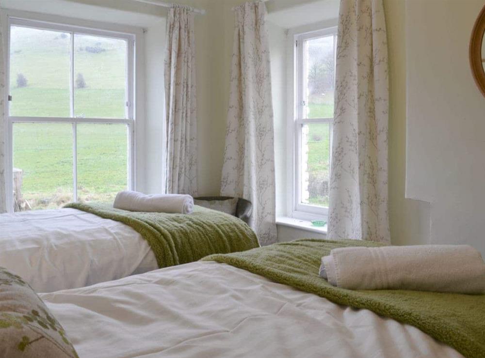Dual aspect windows in twin bedroom at Tyllwyd Farmhouse in Capel Bangor, near Aberystwyth, Dyfed