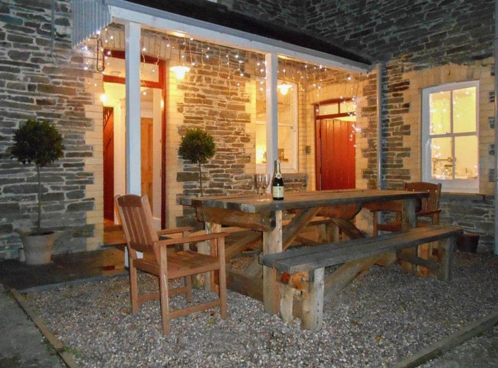 Outdoor seating area at night at Tyllwyd Farmhouse in Capel Bangor, near Aberystwyth, Dyfed