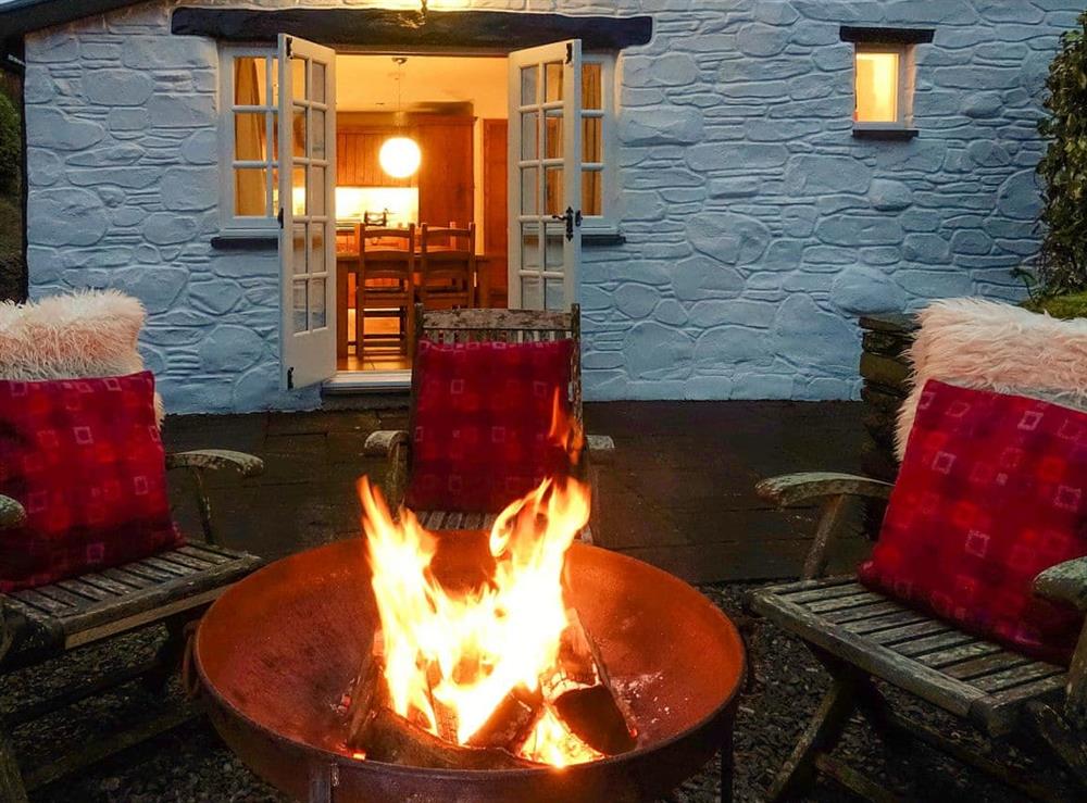 Enjoy an evening by the fire pit on the patio at Tyn Y Ffordd in Machynlleth, Gwynedd