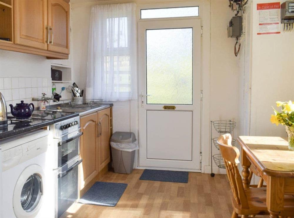 Well-equipped kitchen with convenient dining area at Tynlone Villa in Swyddffynnon, near Devils Bridge, Dyfed