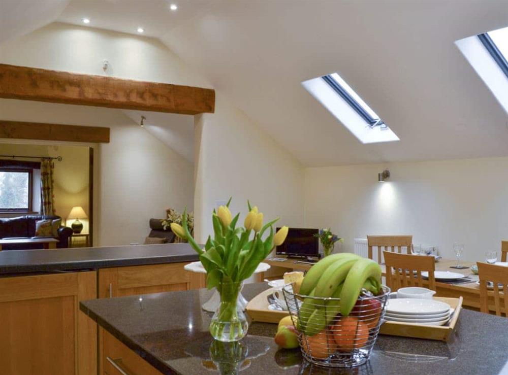 Airy kitchen diner with open aspect to lounge at Tythe Barn in Grindleford, Derbyshire., South Yorkshire