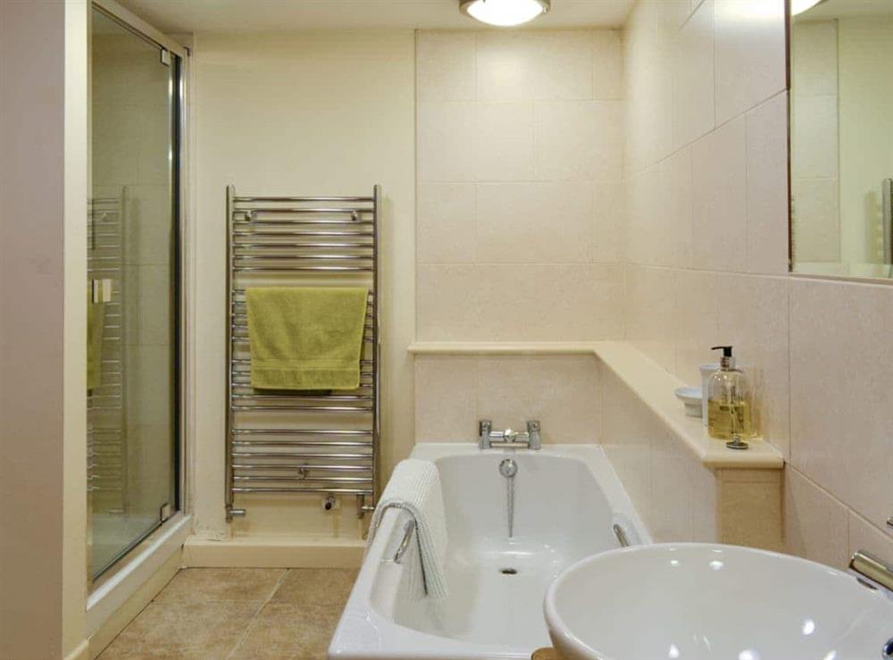 Family bathroom with bath, shower cubicle and heated towel rail at Tythe Barn in Grindleford, Derbyshire., South Yorkshire