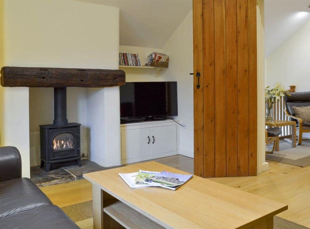 Welcoming living room with wood burner at Tythe Barn in Grindleford, Derbyshire., South Yorkshire