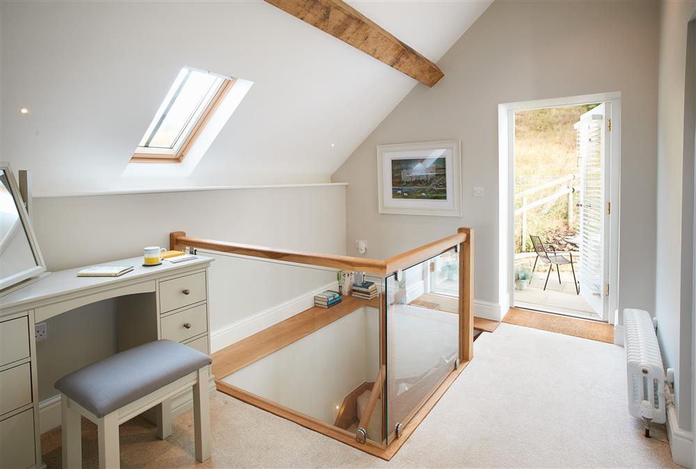 First floor: Landing with exposed beams and dressing table at Unconformity Barn, Hope Bowdler, near Church Stretton