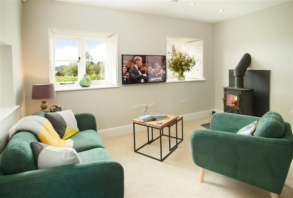 Unconformity Barn, Shropshire: Stylish and contemporary sitting room with cosy wood burning stove at Unconformity Barn, Hope Bowdler, near Church Stretton