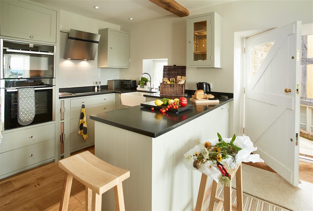 Unconformity Barn, Shropshire: The open-plan living space featuring a well-equipped kitchen at Unconformity Barn, Hope Bowdler, near Church Stretton