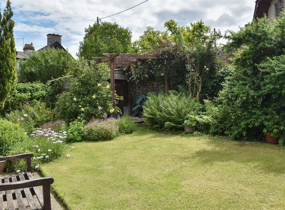 Lovely lawned garden with well-established borders at Underhill Cottage in Arnside, near Grange-over-Sands, Cumbria