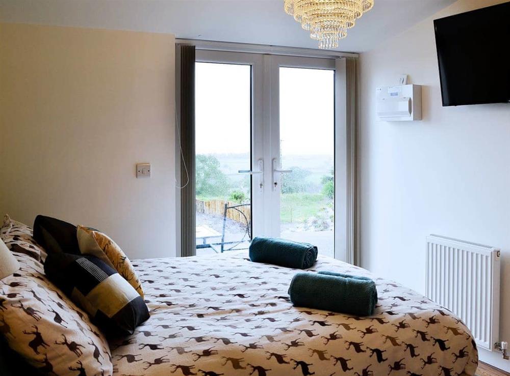 Delightful double bedroom with access to patio at The Retreat, 