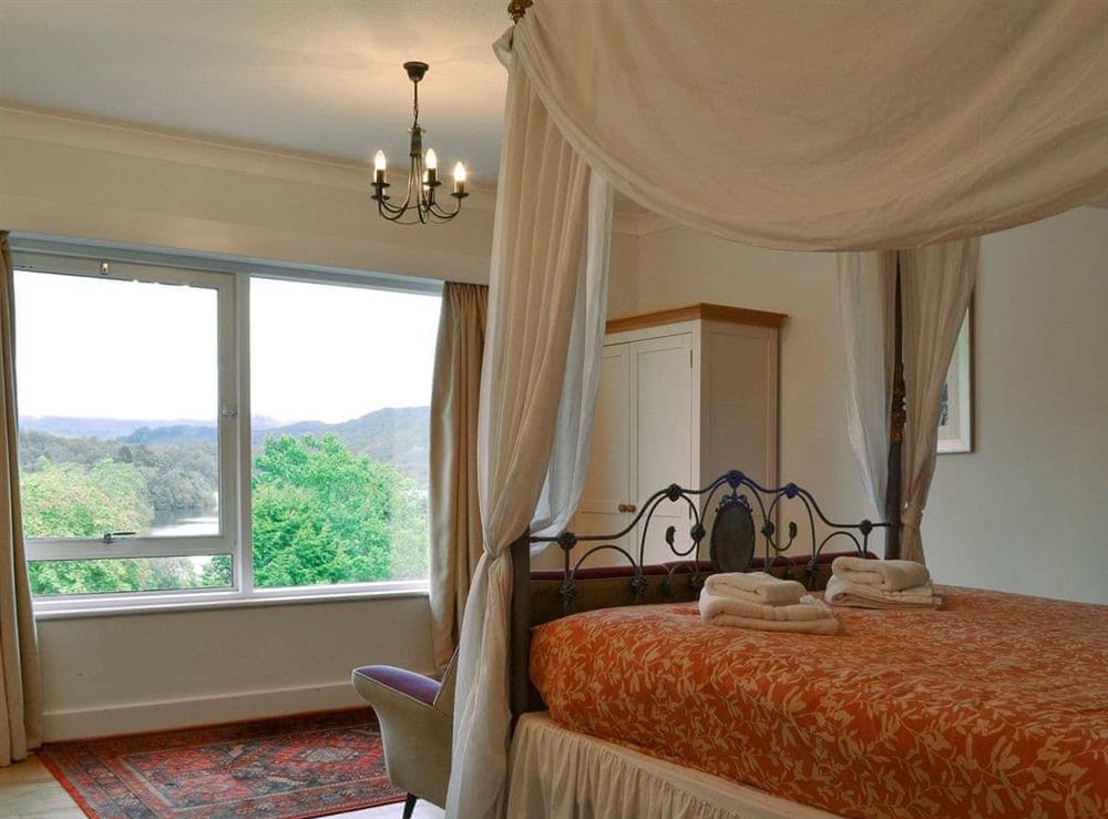 Attractive bedroom with double four-poster bed and stunning views at Unerigg in Grasmere, Cumbria