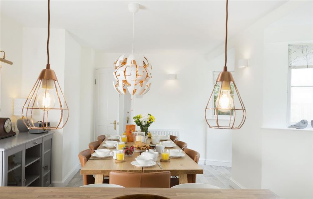 The open-plan kitchen looks toward the dining area at Upper End House, Shipton-under-Wychwood