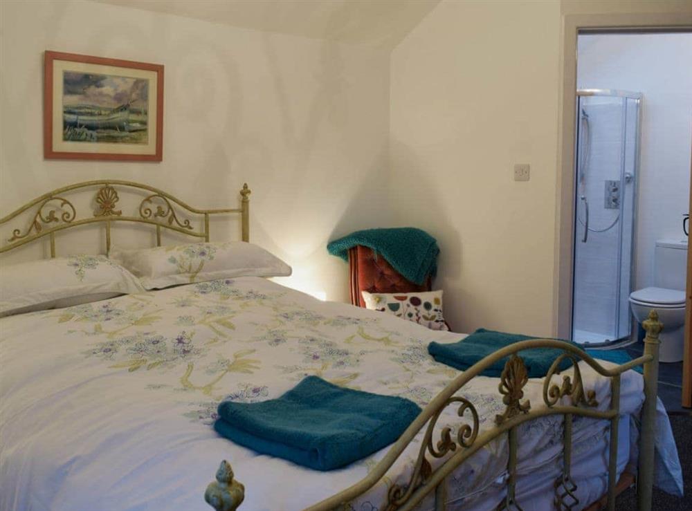 Bedroom with kingsize bed and en-suite shower room (photo 2) at Ravens Roost, 