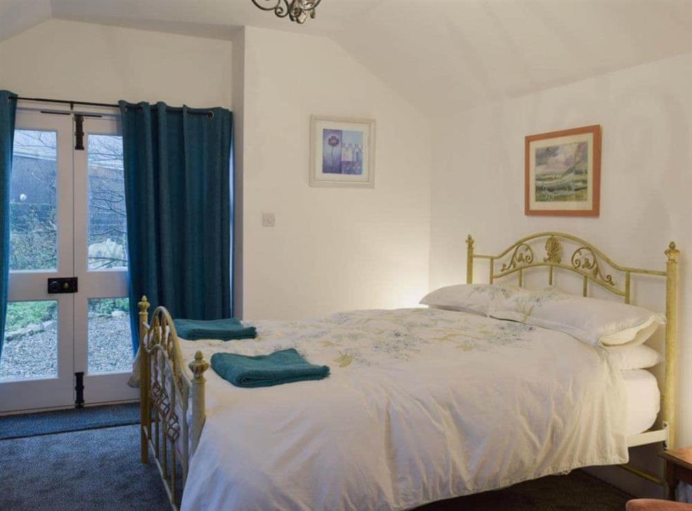 Bedroom with kingsize bed and en-suite shower room at Ravens Roost, 