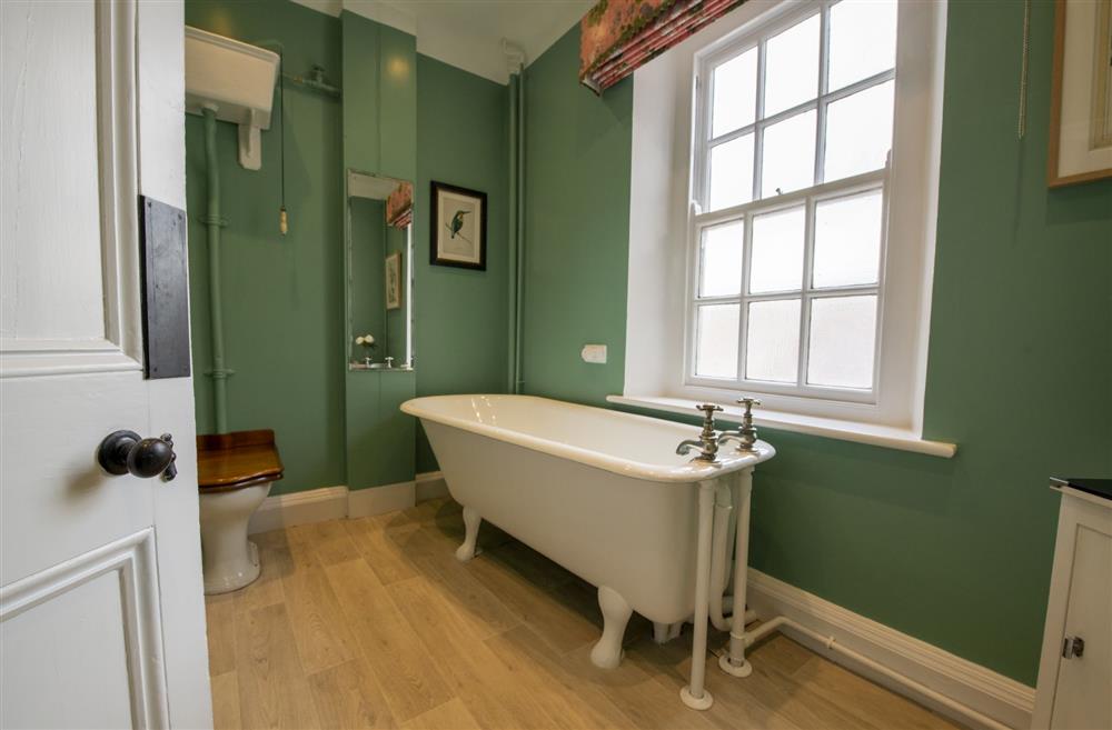 West wing family bathroom with free-standing, roll-top bath at Upper Helmsley Hall, York