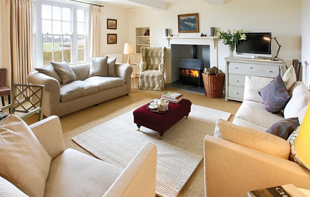 Drawing room with wood burning stove at Upper Mowley, Titley