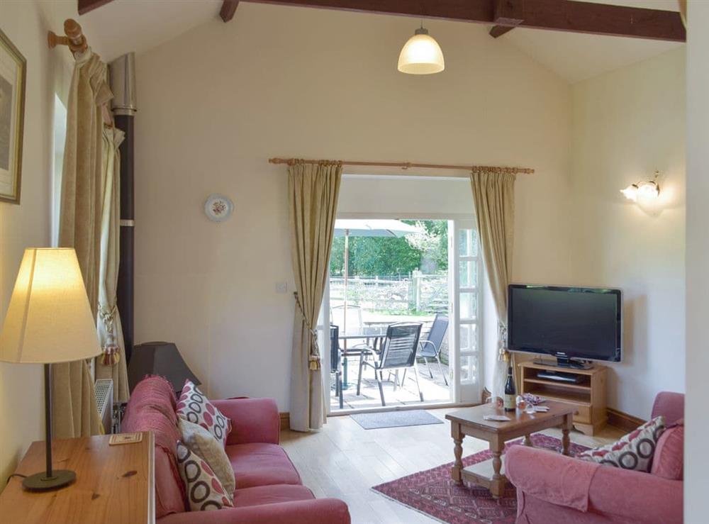Spacious living area with exposed wood beams at Cothi Cottage, 