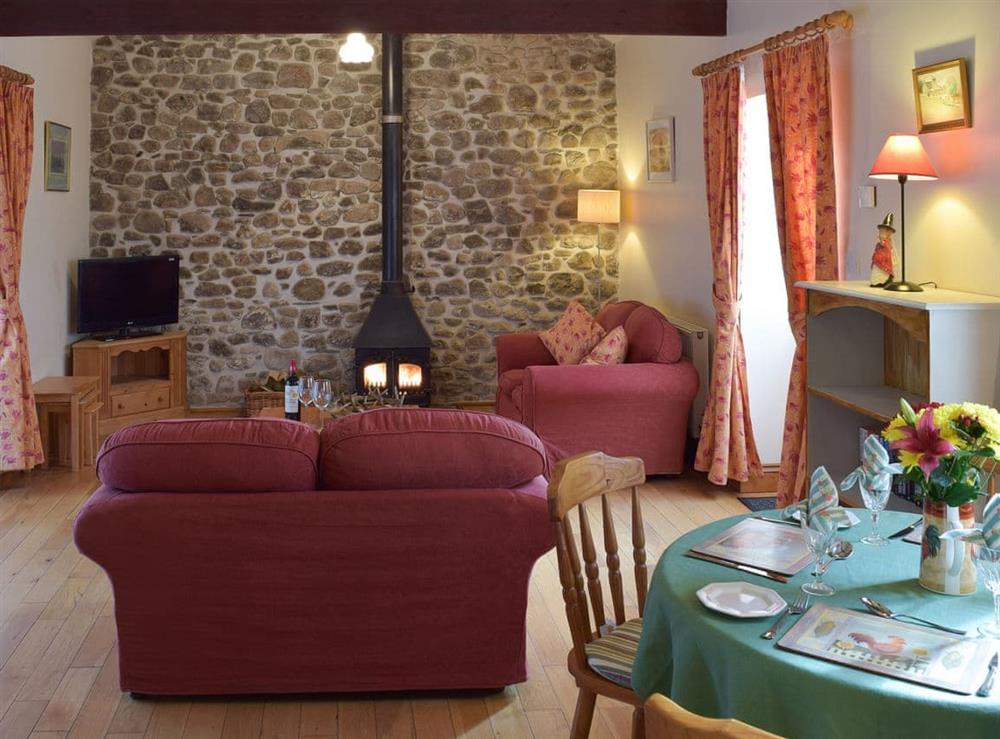 Living room with dining area at Gwili Cottage, 
