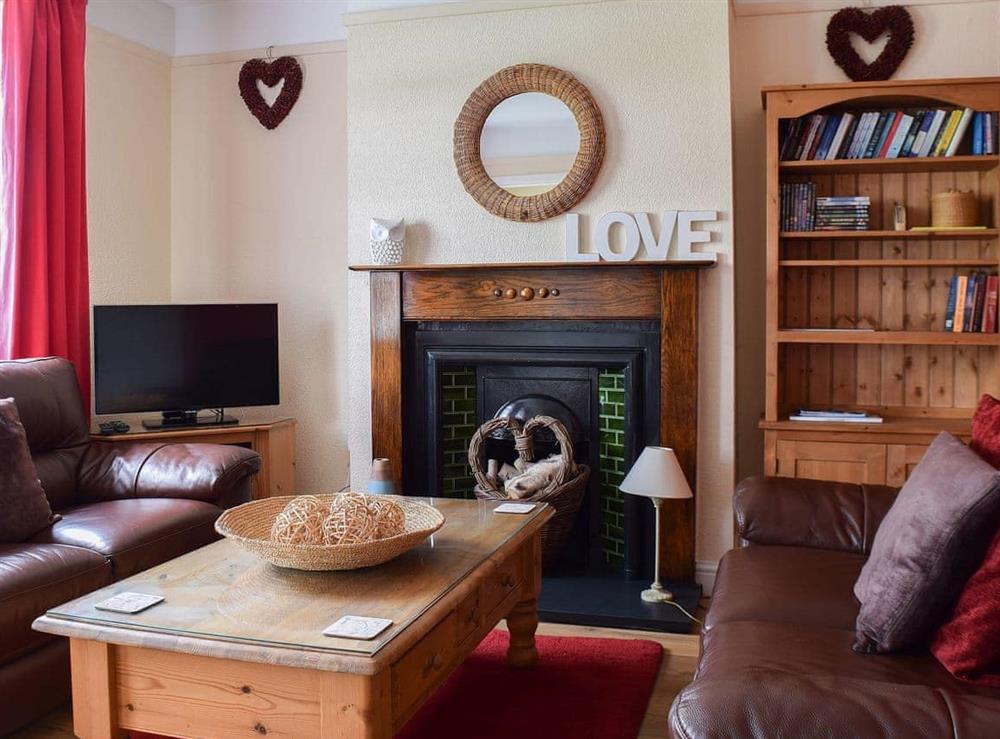 Delightful living room with feature fireplace at Valentine Cottage  in Keswick, Cumbria