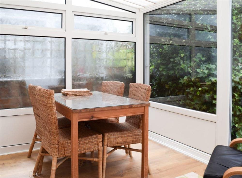 Lovely conservatory with dining table at Valentine Cottage  in Keswick, Cumbria