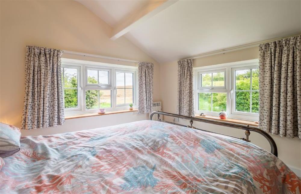 Master bedroom with views out over the fields at Valentine Cottage, Snape Watering