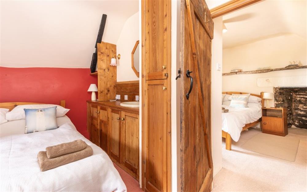 Looking from the bedroom in the hall to the main bedroom at Valley Cottage in Slapton